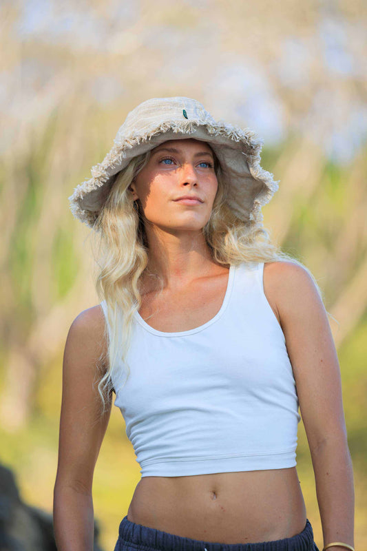 Hemp Linen Sun Hat in Neutral Stripe worn outdoors.