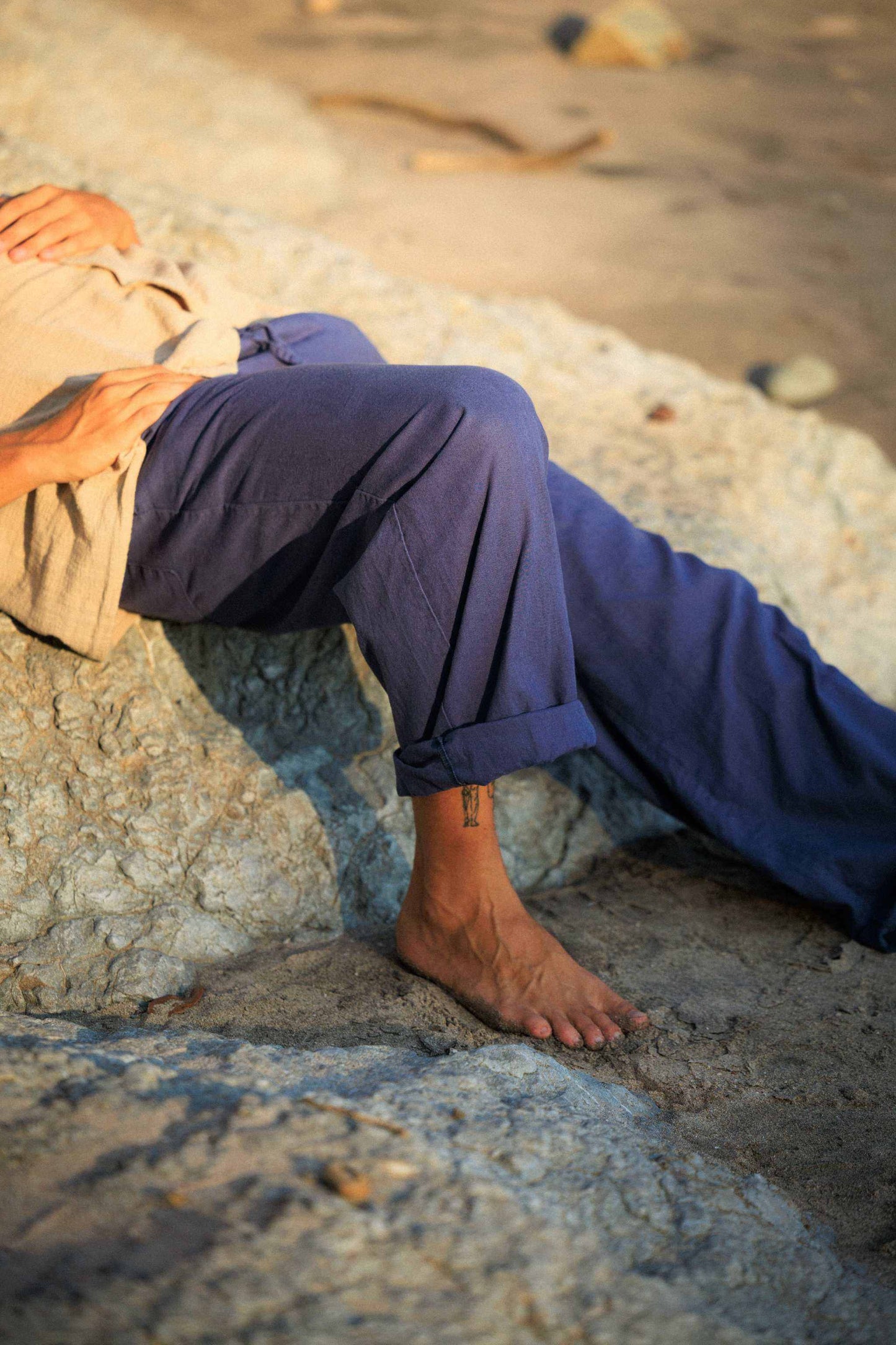 Unisex hemp linen & organic cotton pants in navy, worn casually outdoors.