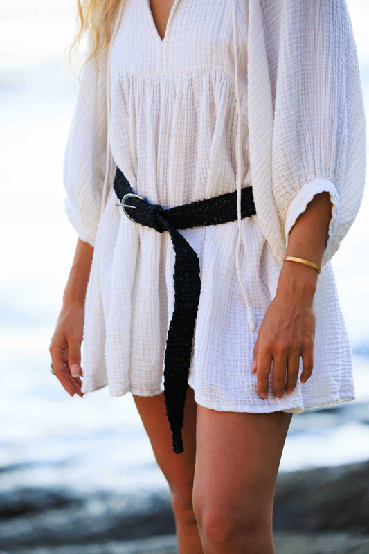 Eco-friendly handmade hemp belt in black, worn over a white dress, featuring a fashionable D-Ring buckle.
