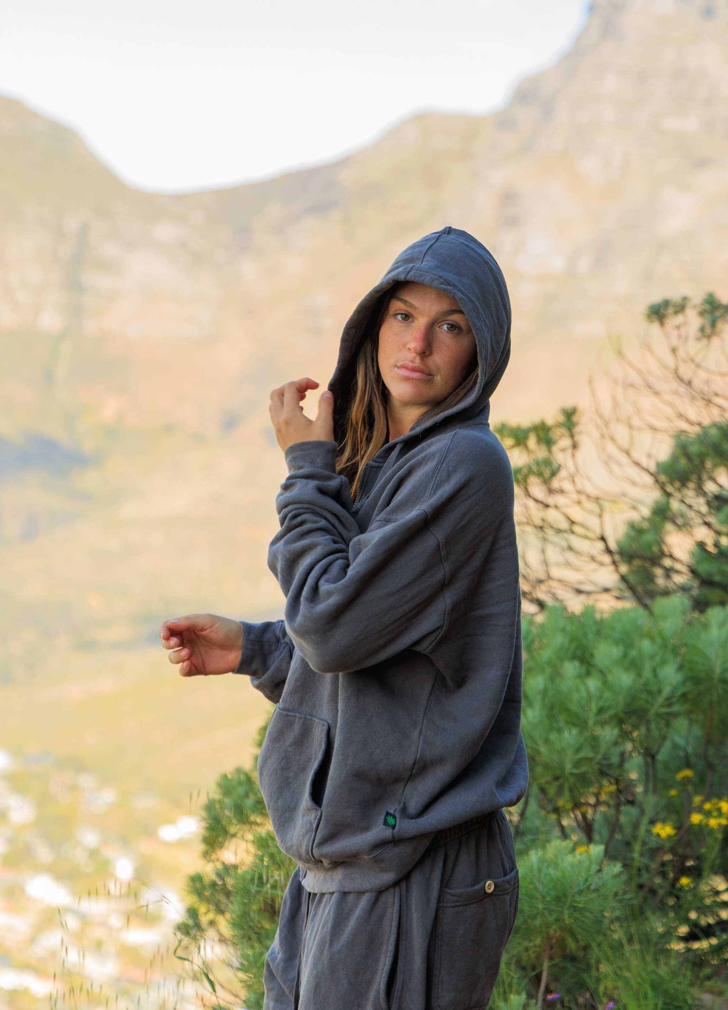 Woman wearing charcoal gray hemp hoodie zip sweatshirt outdoors