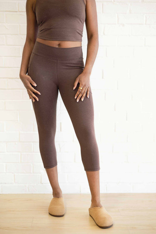 Woman wearing brown hemp capri leggings with pockets, soft breathable eco-friendly activewear for yoga and everyday use