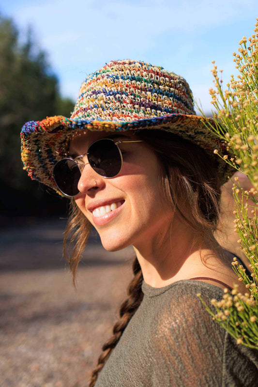 Handmade hemp crochet sun hat with multicolored stripes, perfect for summer style.