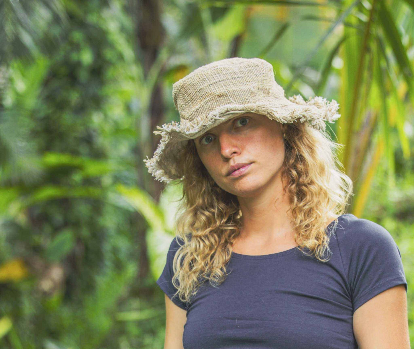 Eco-friendly hemp hat providing sun protection in a natural garden setting.