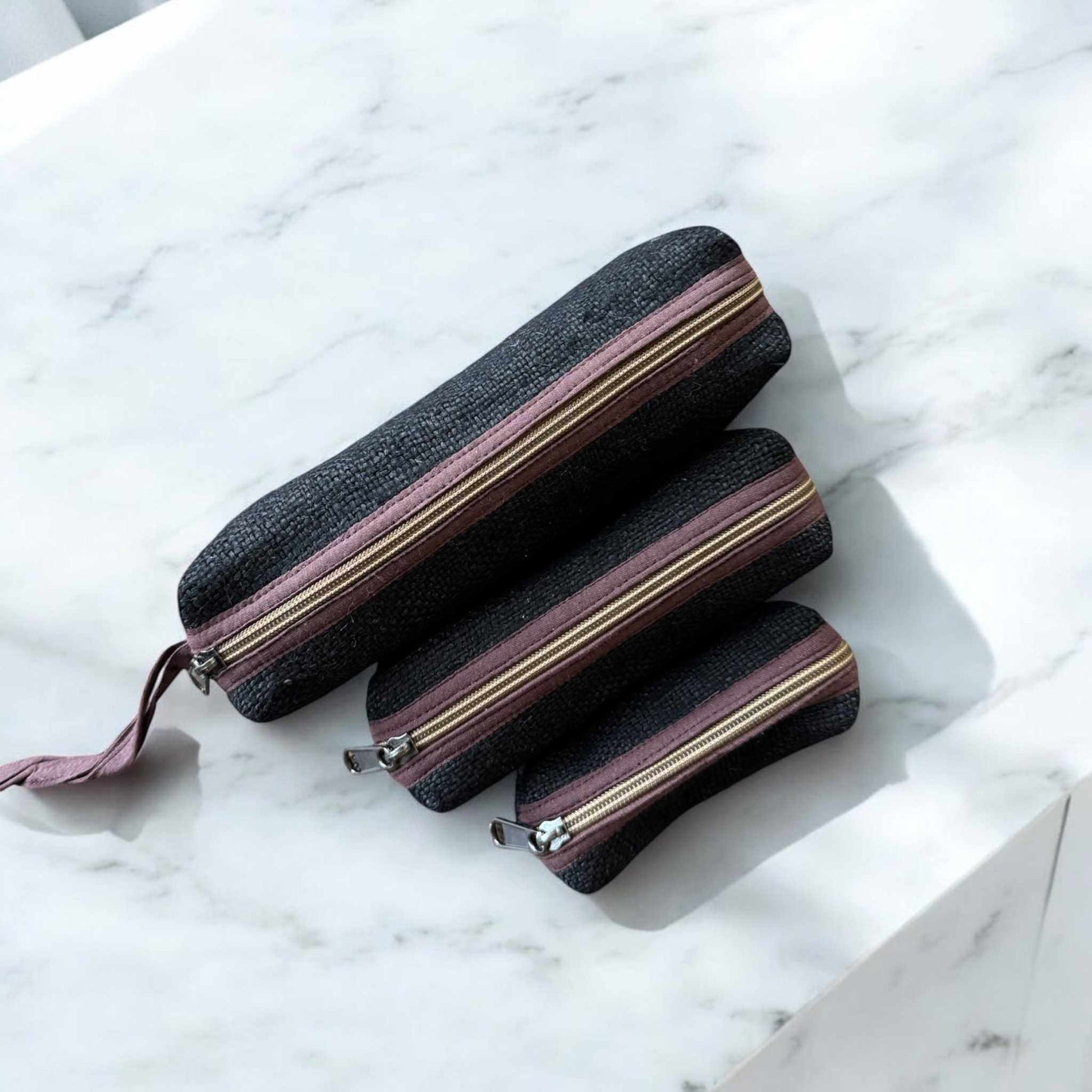 Set of 3 eco-friendly zippered pouches made of durable black hemp with purple zippers for versatile storage
