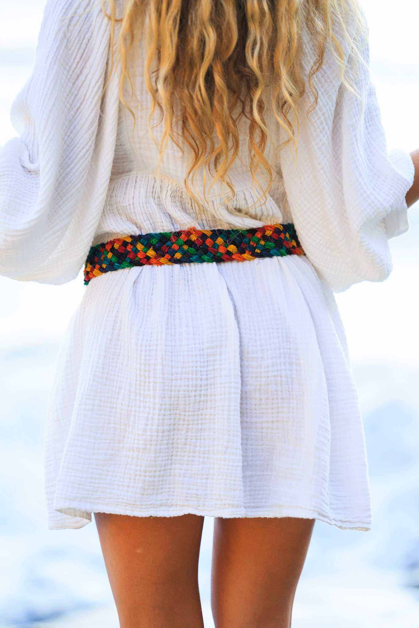 Multicolor braided hemp belt worn with white boho dress, eco-friendly unisex accessory