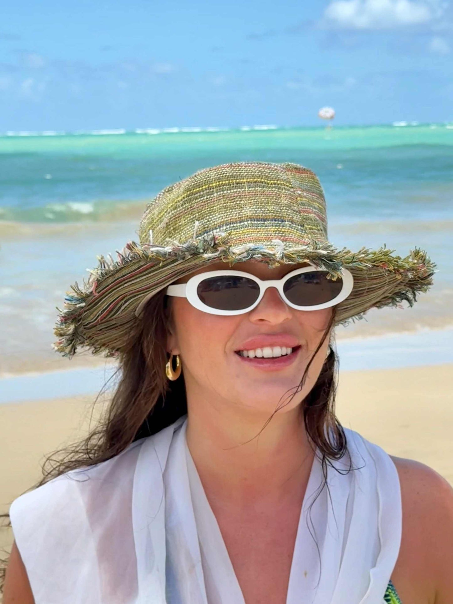 Hemp hat with a wide brim on a person at the beach.
