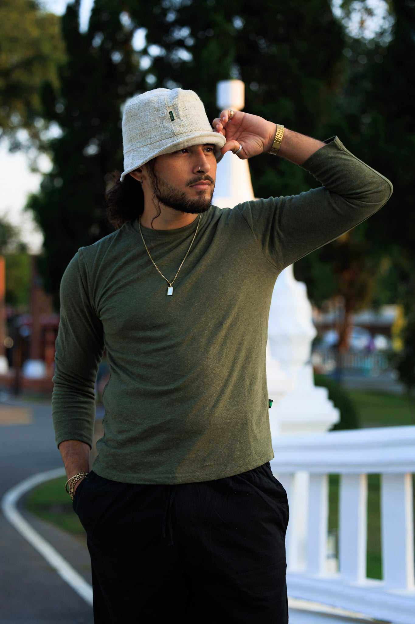Hemp bucket hat in natural color worn by a person outdoors, showcasing eco-friendly fashion.