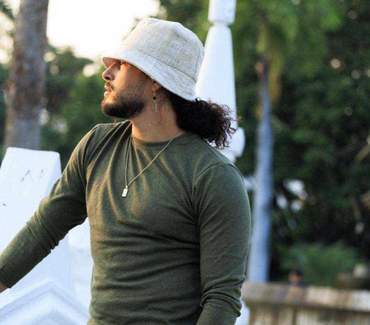 Man wearing natural-colored hemp bucket hat outdoors.