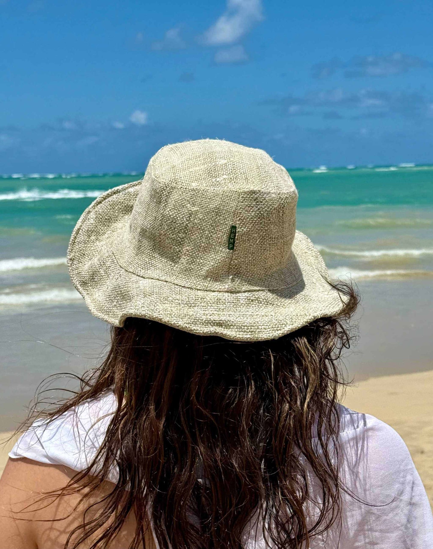 Eco-friendly unisex hemp hat in natural color by the beach.