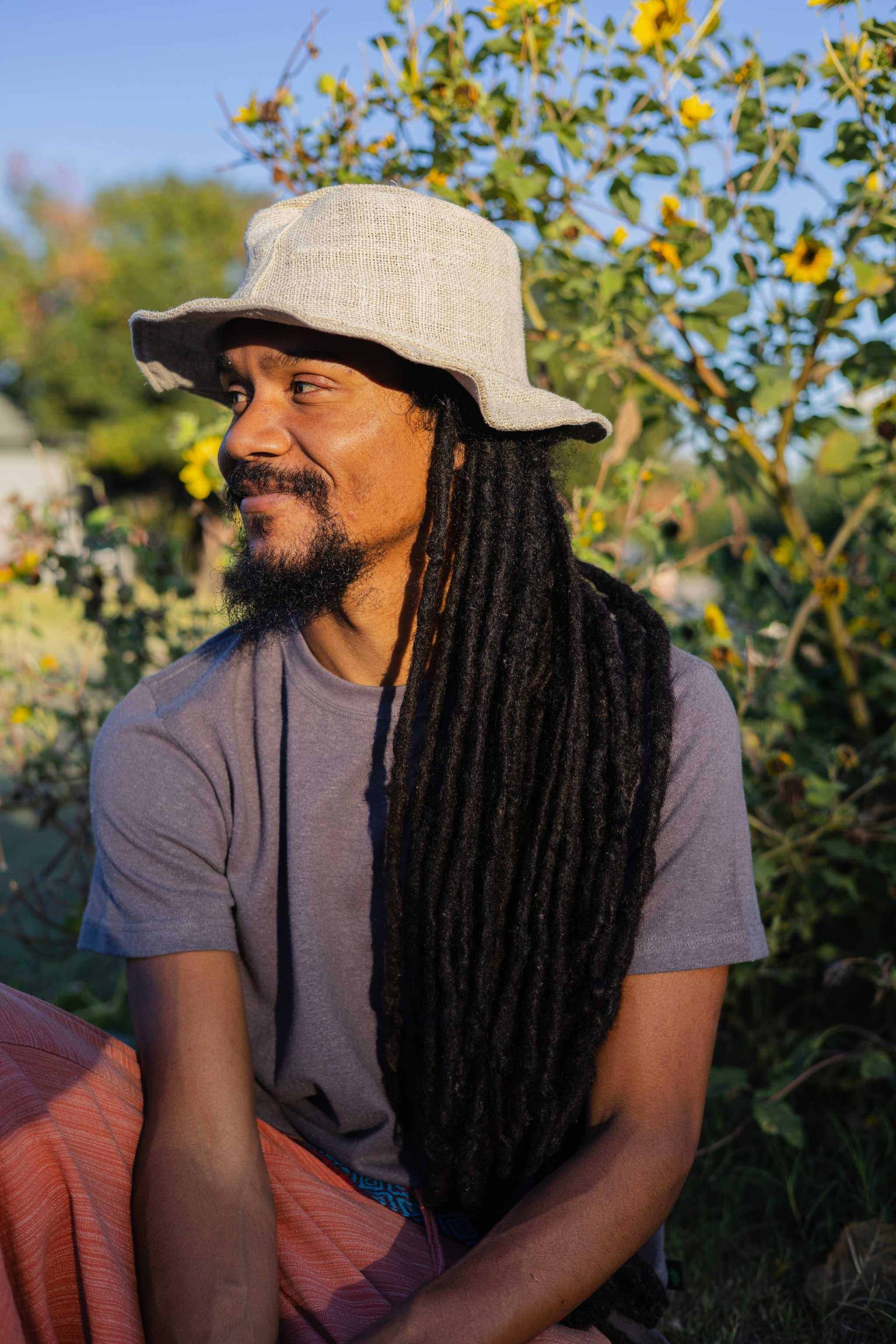 Natural hemp hat worn outdoors, featuring eco-friendly, unisex design suitable for summer activities.