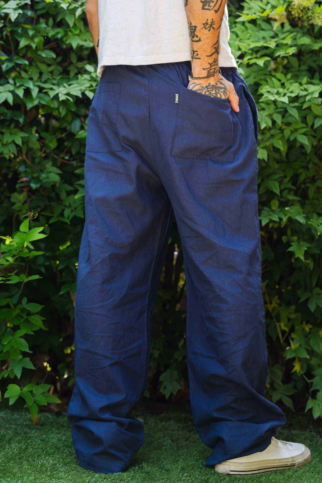 Unisex hemp linen and organic cotton pants in navy, featuring relaxed fit and elastic waistband.