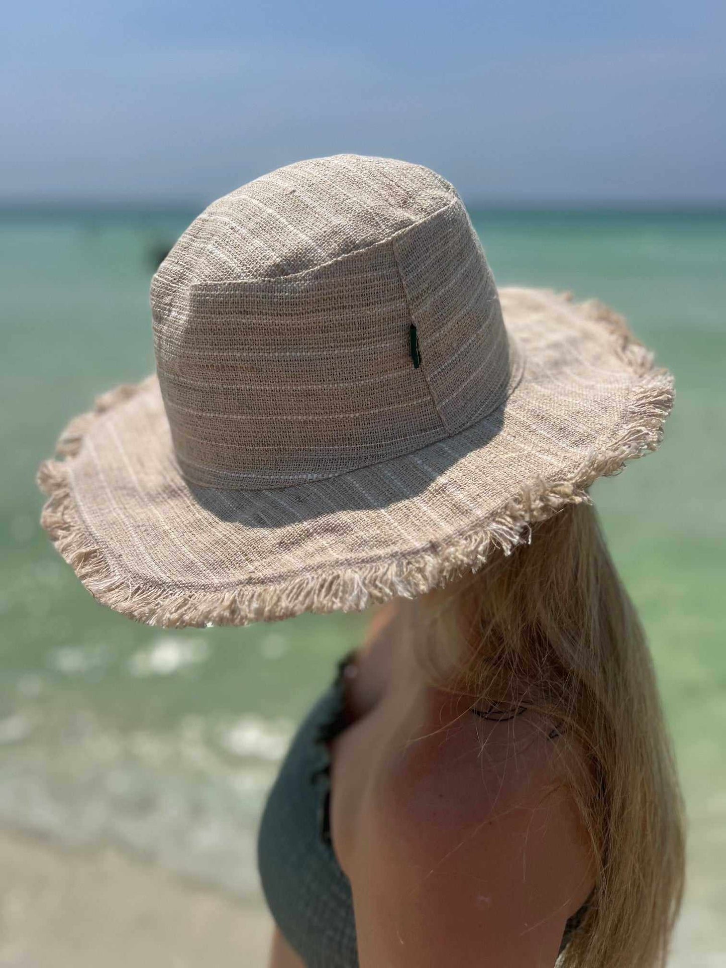 Hemp Linen Sun Hat - Neutral Stripe on beach.