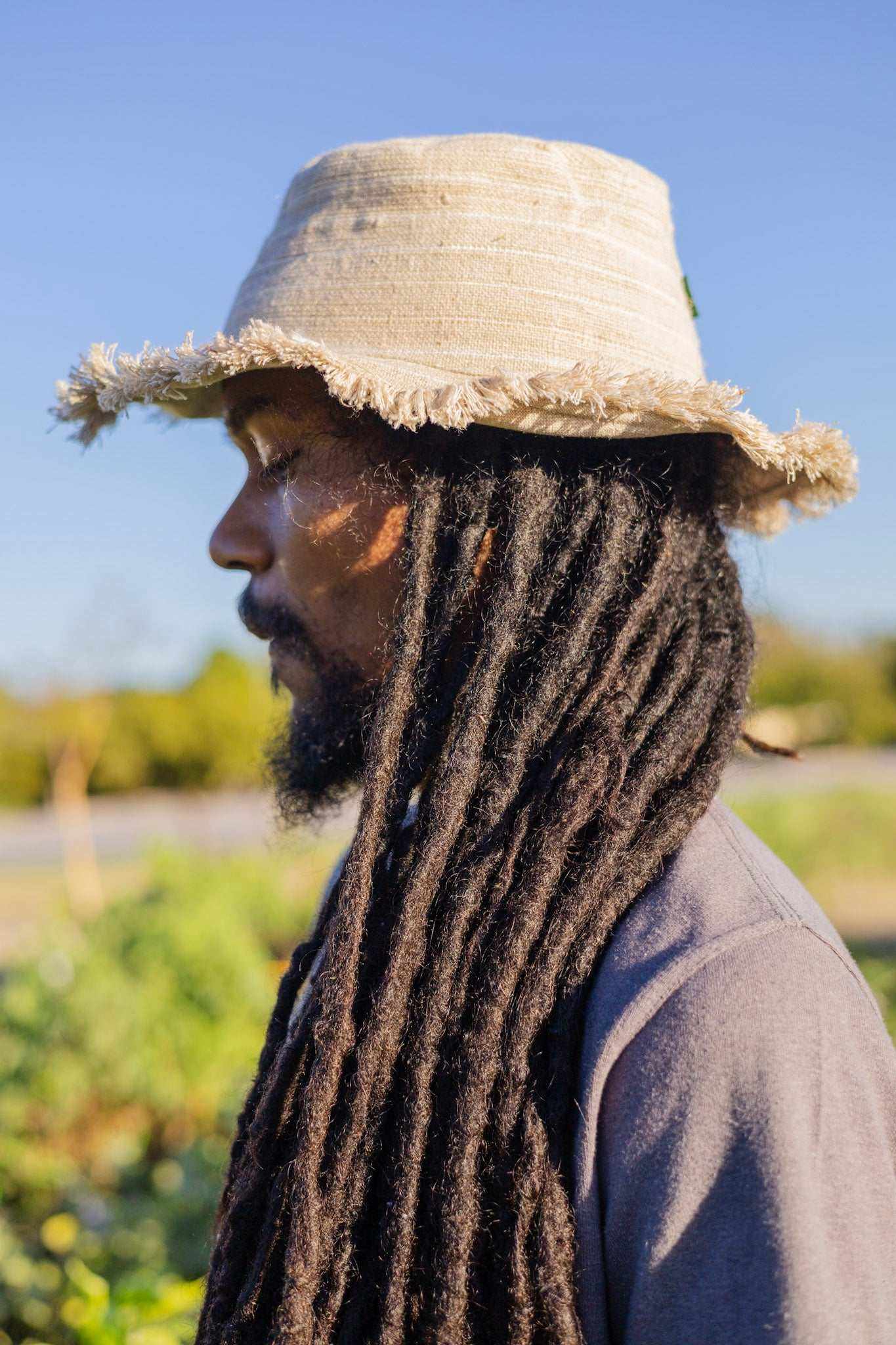 Hemp Linen Sun Hat with Neutral Stripe Design on Person Outdoors