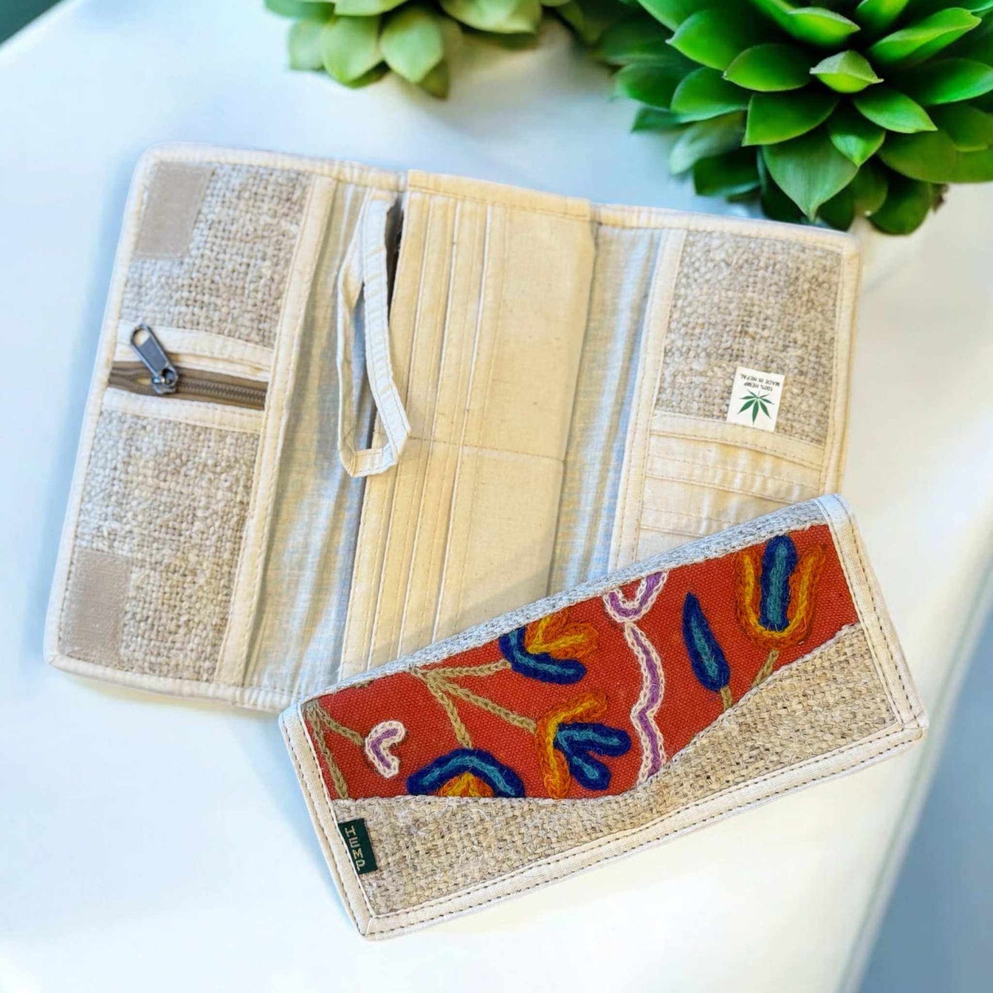 Eco-friendly hemp wallet with floral embroidery, featuring multiple compartments and card slots, handcrafted in Nepal.