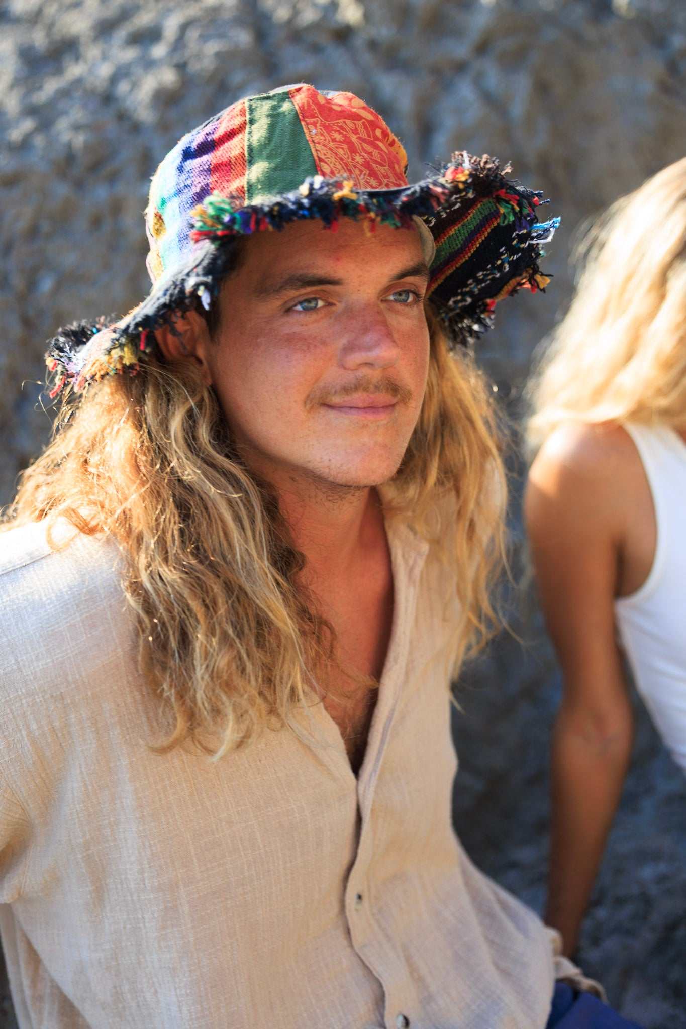 Hemp patchwork sun hat with wide brim, eco-friendly design worn by a person outdoors.