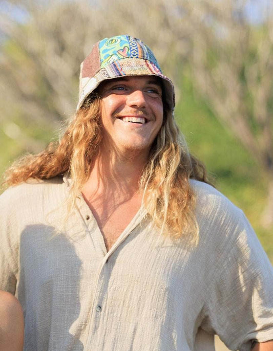 Hemp hat - eco-friendly patchwork bucket hat worn by a person outdoors.