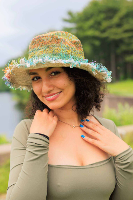 Woman wearing eco-friendly multi-color rainbow hemp hat with fringed brim outdoors