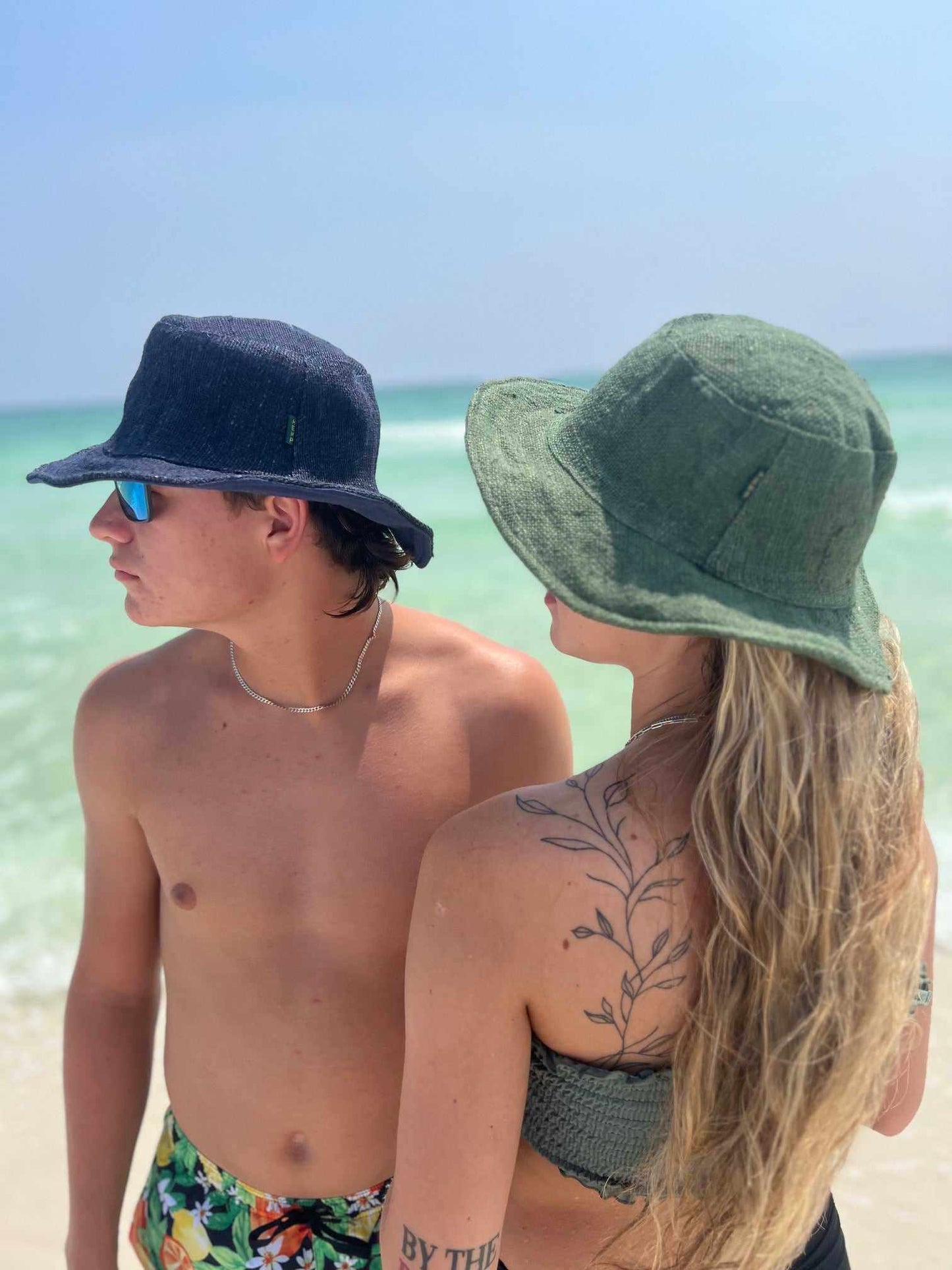 Wide brim hemp hats in navy and green at the beach.