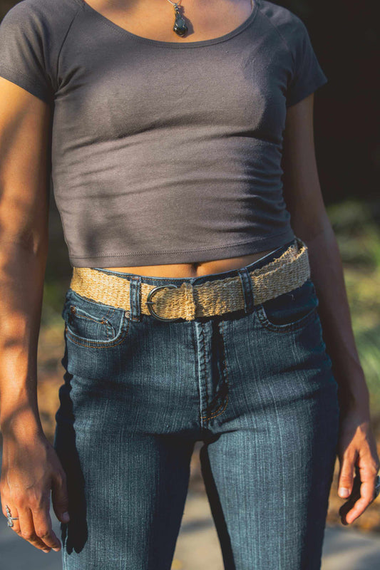 Eco-friendly natural hemp woven belt with traditional pin buckle on person wearing jeans and crop top