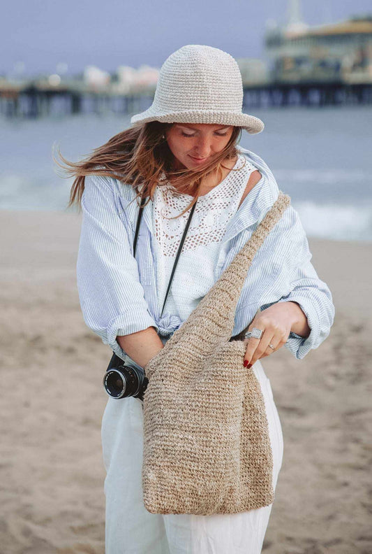 Crochet Floppy Hat in light beige woven natural fiber with a rounded crown and wide, softly curved brim