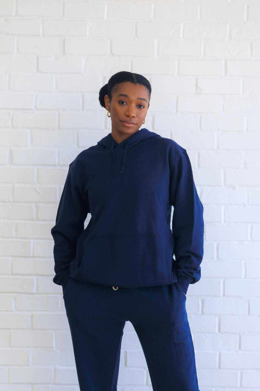 Hemp Hoodie in dark navy fleece, featuring a relaxed unisex fit, drawstring hood, and front kangaroo pocket