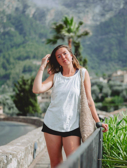 Women's hemp tank top in terracotta, white, and black, made from 55% hemp and 45% organic cotton, featuring a scoop neckline and curved hem, ideal for yoga and summer wear