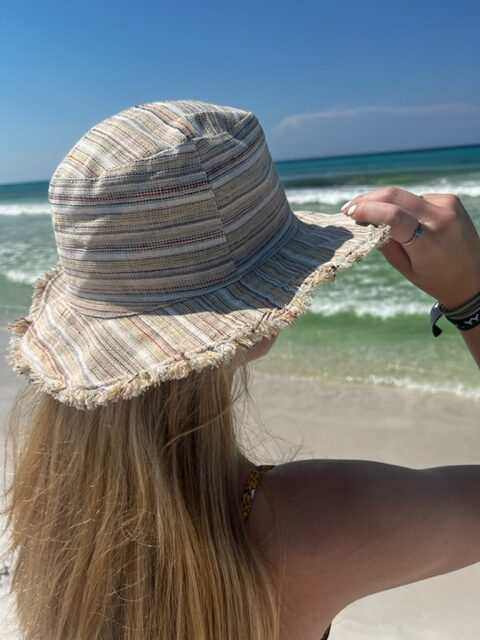 Hemp linen sun hat with wide brim worn on the beach.