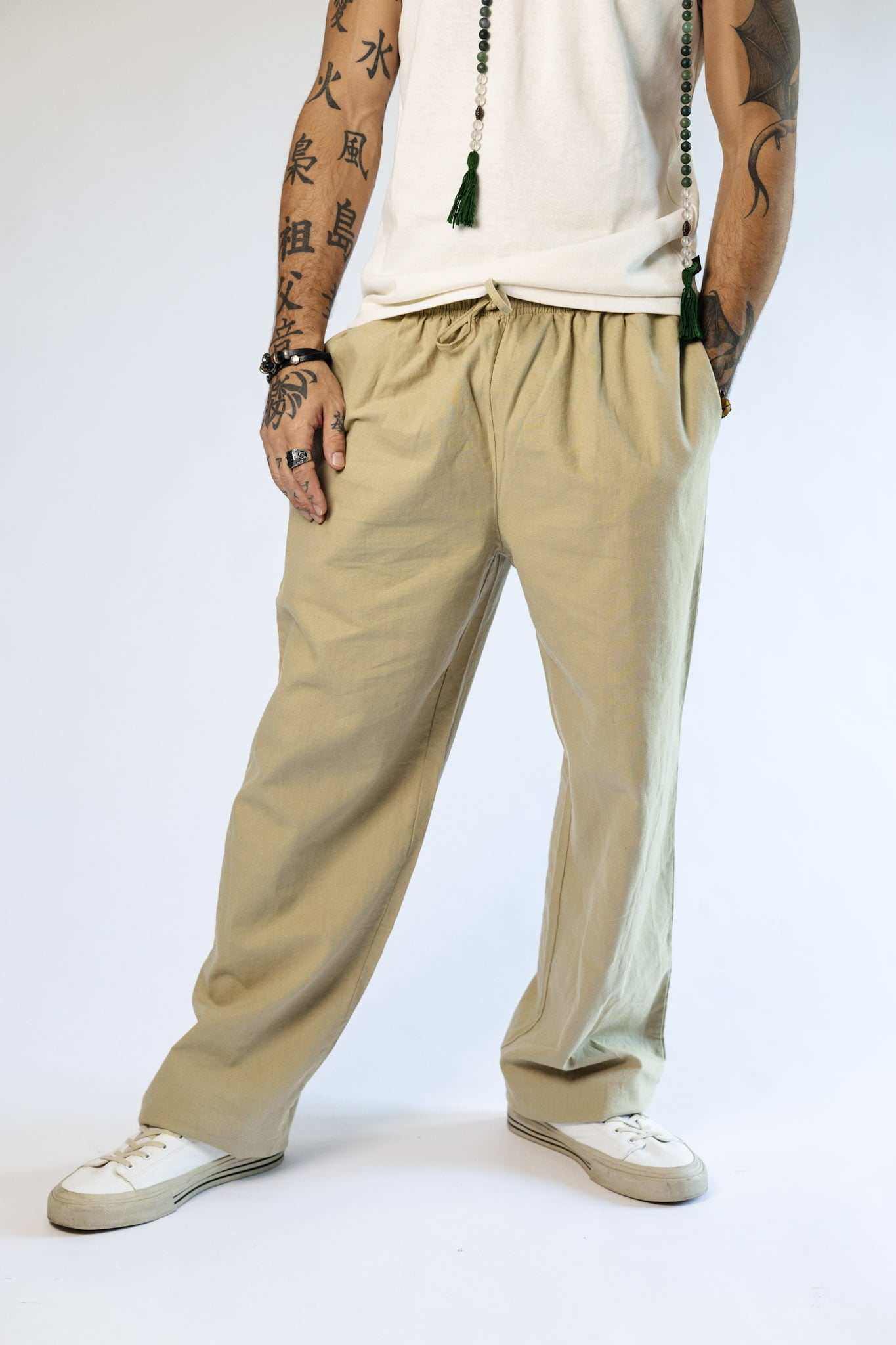 Unisex hemp linen and organic cotton pants in beige, relaxed fit with elastic waistband, suitable for casual wear.