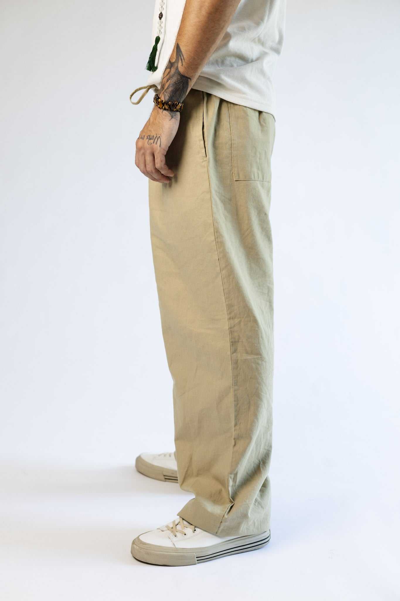 Unisex hemp linen and organic cotton pants, relaxed fit, taupe color, side view.