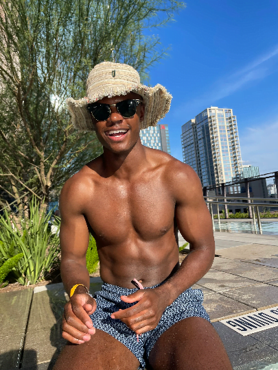 Hemp Linen Sun Hat with wide brim worn outdoors by a person sitting on a sunny day, showcasing eco-friendly style and sun protection.