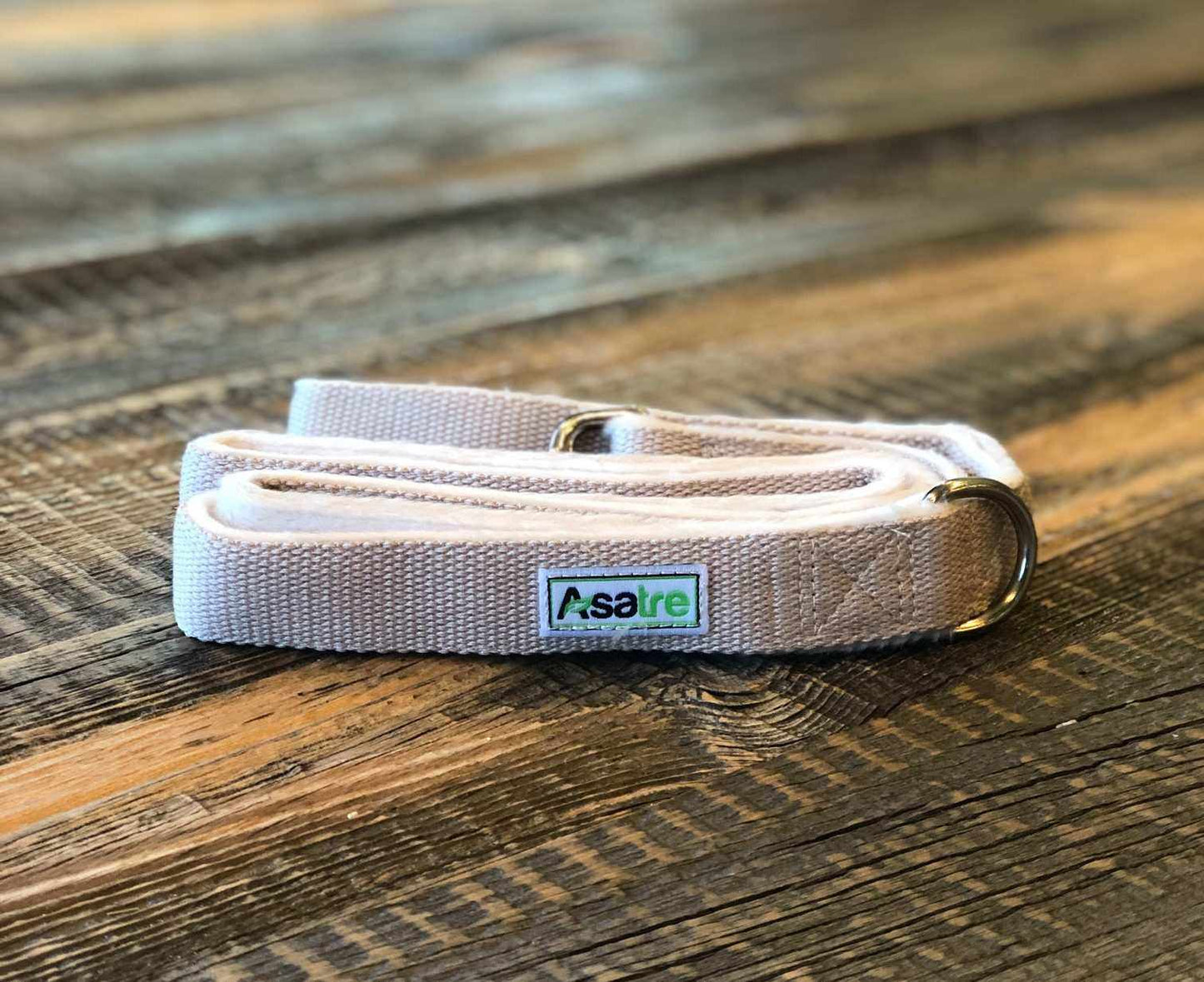 Tan hemp dog leash with fleece lining and rust-proof chrome D-ring on wooden surface