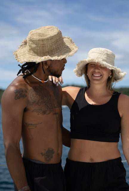 Eco-friendly hemp hats worn by a man and woman, offering sun protection and comfort.