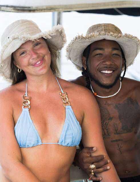 Eco-friendly hemp hats on a couple outdoors, showcasing wide-brim sun protection and natural style.