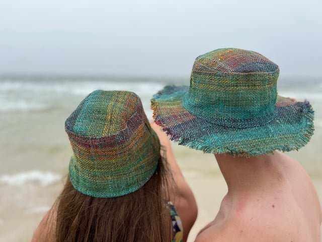 Rainbow hemp bucket hat on woman outdoors, showcasing vibrant colors and sustainable style.