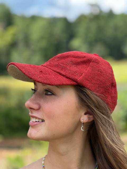 woman wearing red hemp baseball cap with adjustable metal clasp outdoors