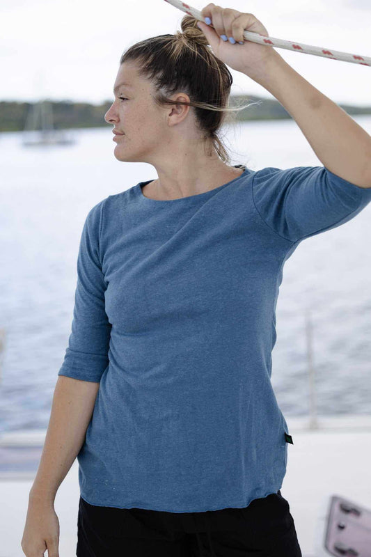 Woman wearing blue relaxed fit 3/4 sleeve hemp shirt on a boat