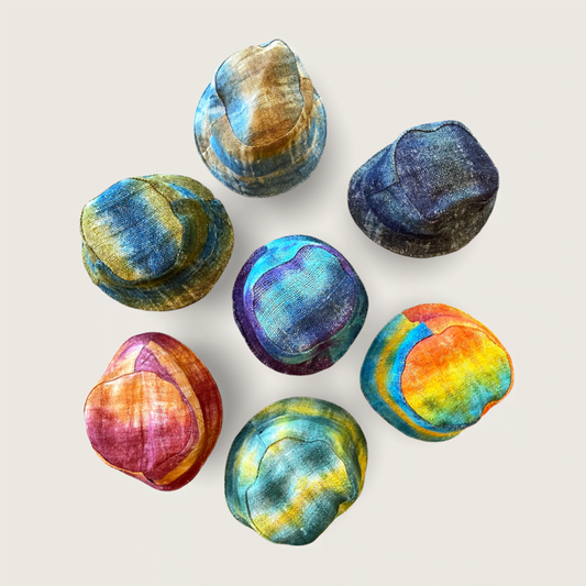 Collection of colorful hemp tie dye bucket hats in various vibrant patterns.