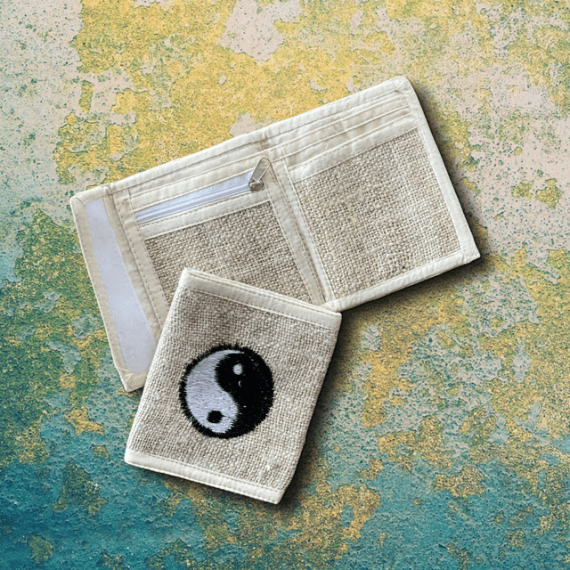 Handmade Himalayan hemp bi-fold wallet with Yin Yang emblem, eco-friendly and durable with multiple compartments.