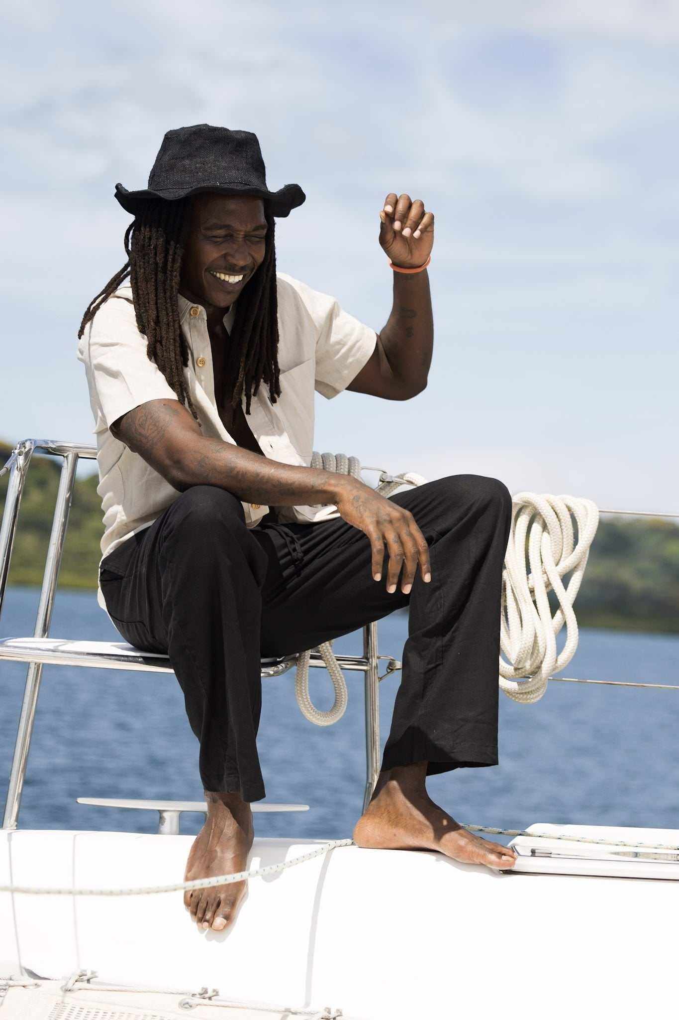 Unisex Hemp Linen and Organic Cotton Pants worn on a sailboat, showcasing relaxed fit and breathable fabric.
