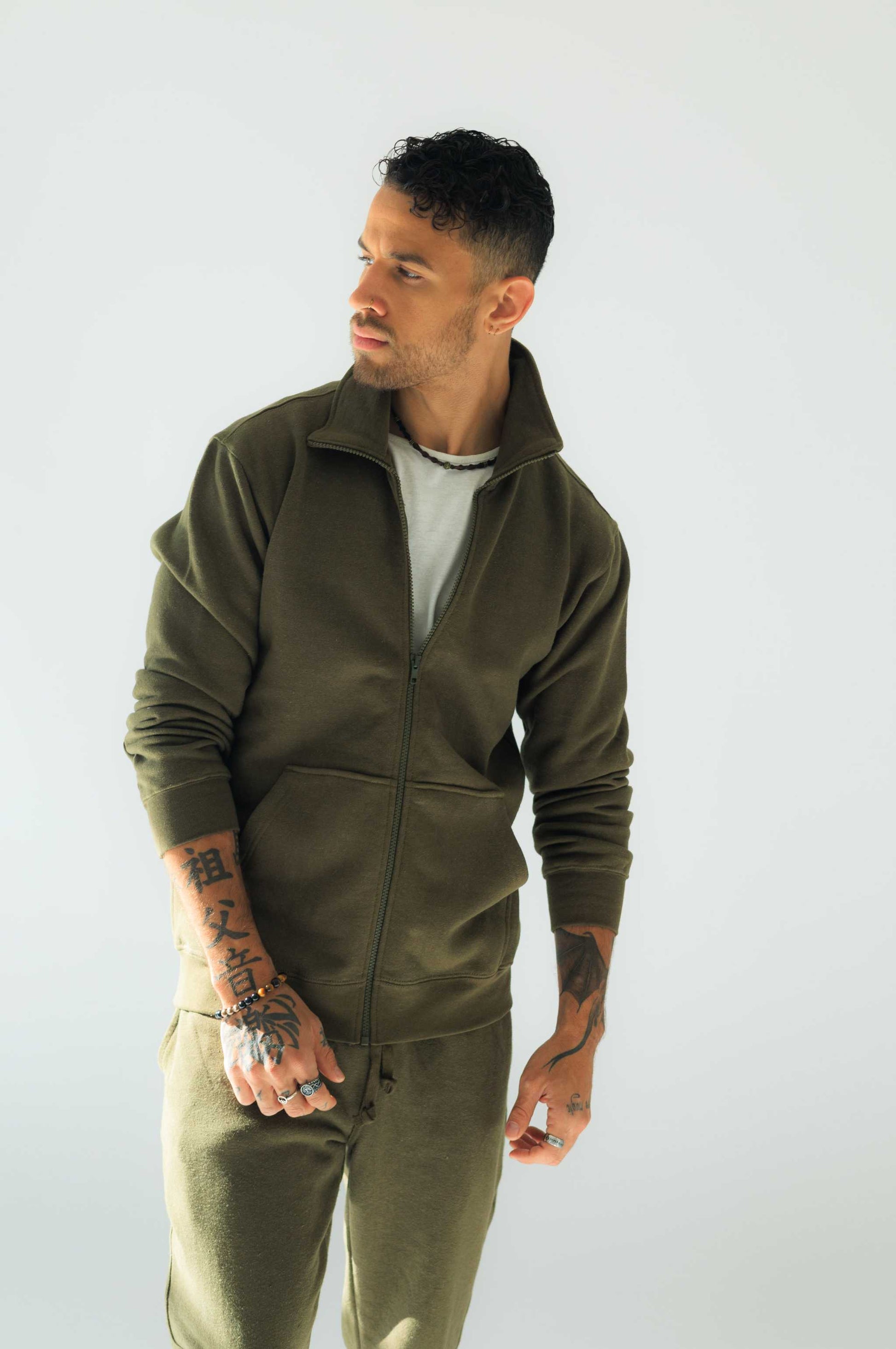 Eco-friendly hemp jacket in olive, featuring organic cotton and hemp fleece, worn by model.