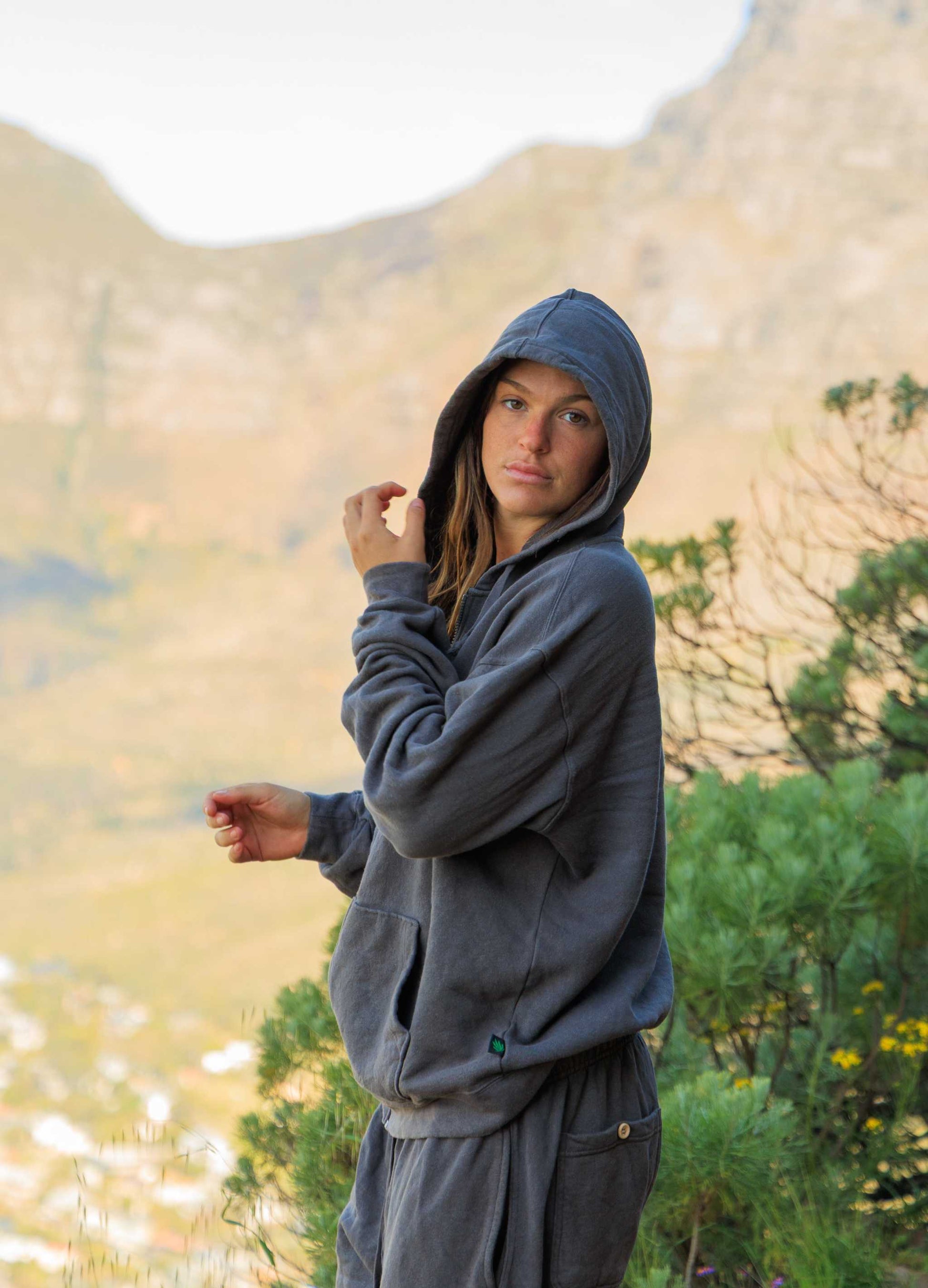 Woman wearing charcoal gray hemp hoodie zip sweatshirt outdoors