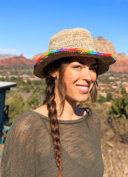 Hemp crochet sun hat with rainbow trim, handmade in Nepal, perfect for summer.