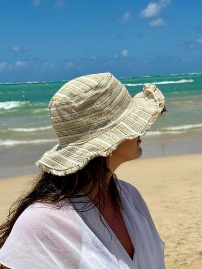 Handmade hemp linen sun hat with wide brim and neutral stripes, perfect for summer beach outings.