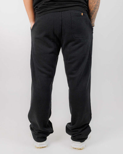 Person wearing black pants on a white background