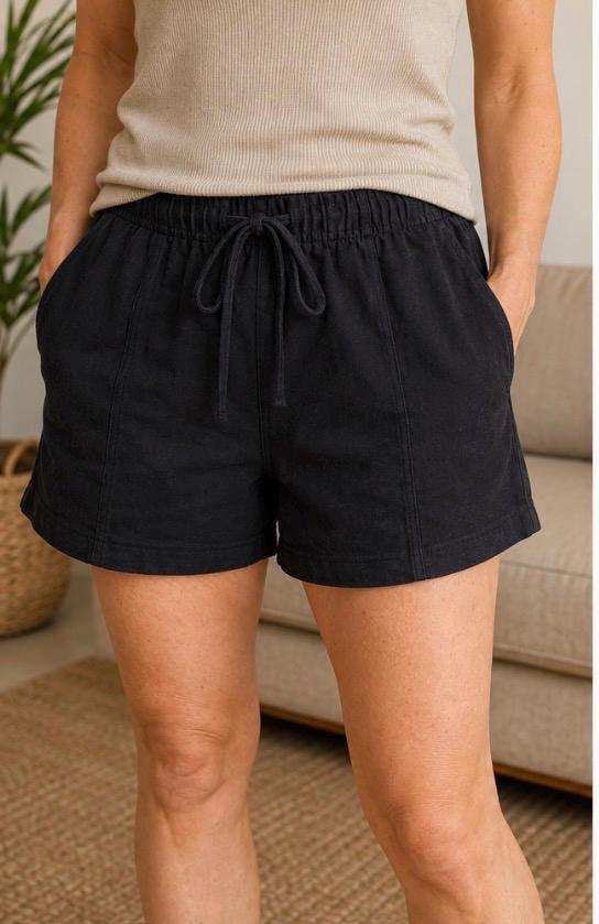 Women wearing black sustainable hemp and organic cotton lounge shorts with drawstring waist and pockets outdoors
