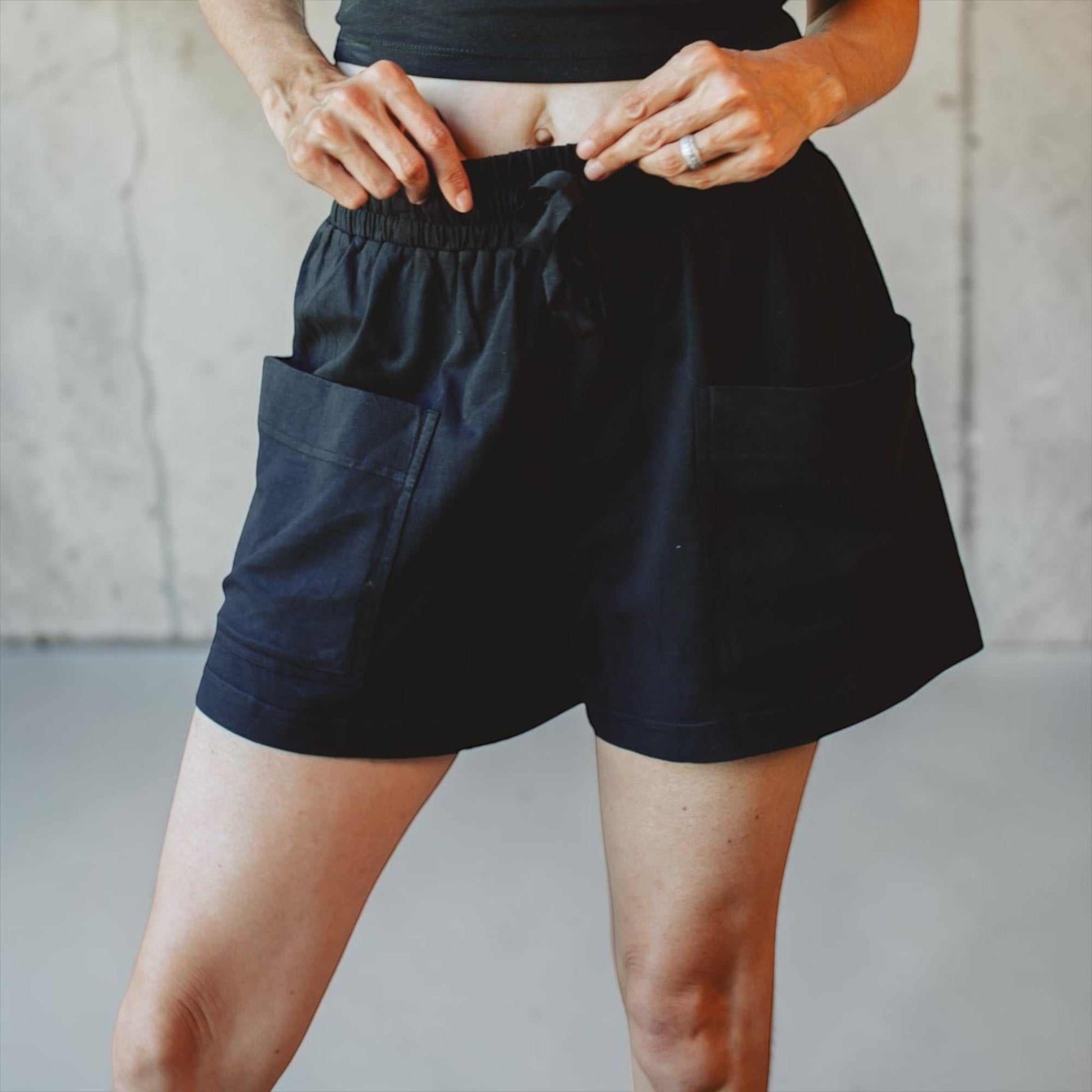 Black hemp shorts for women with elastic waistband and side pockets, made from sustainable hemp and organic cotton blend.