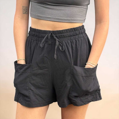 Black hemp shorts for women with elastic waistband and pockets, made from sustainable hemp and organic cotton blend.