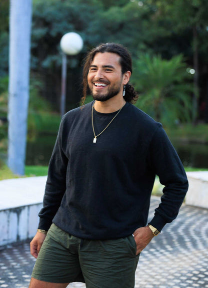 man wearing black hemp and organic cotton fleece crew sweatshirt outdoors
