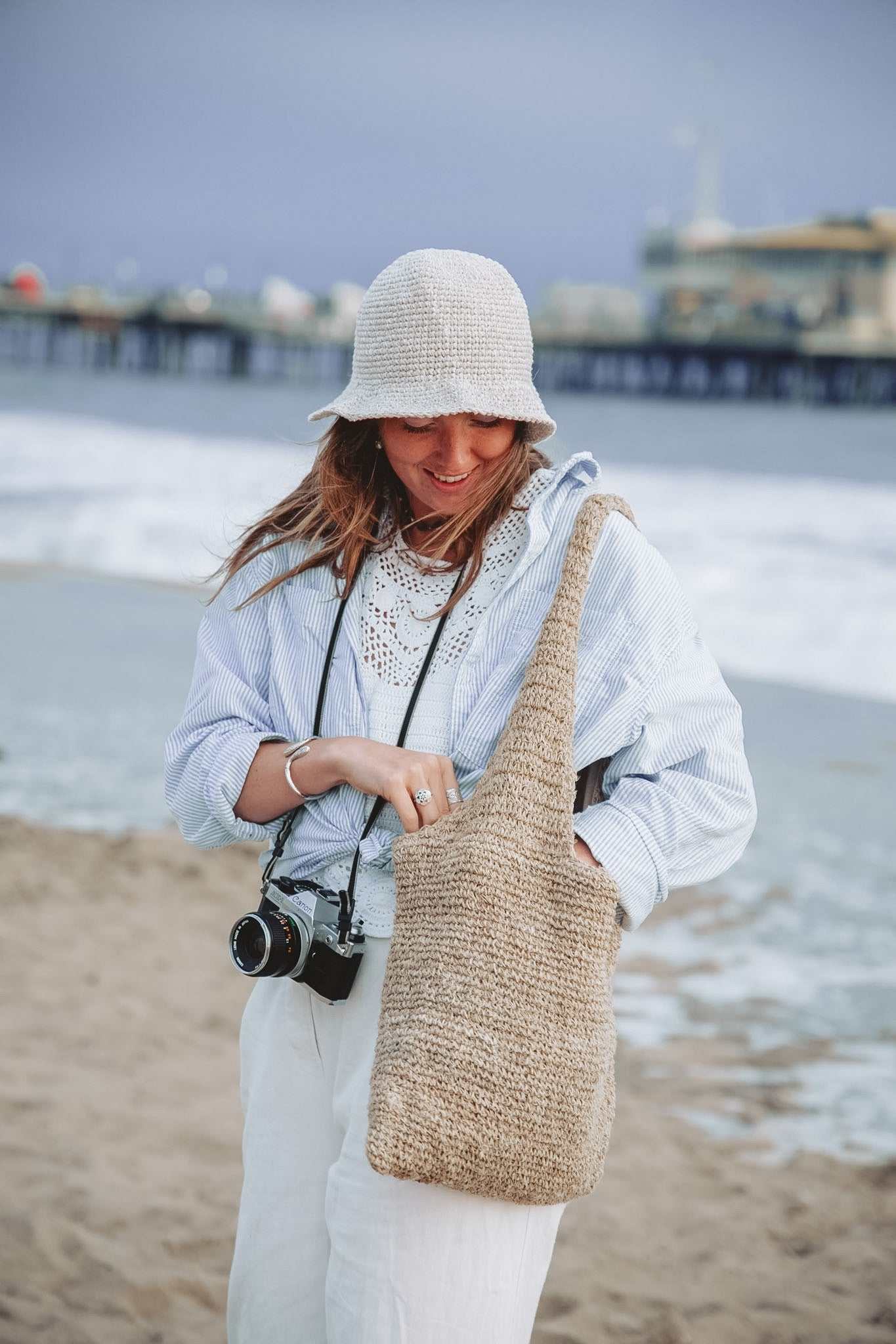 Handmade foldable hemp beach hat with wide brim, natural beige crochet design for sun protection and summer travel