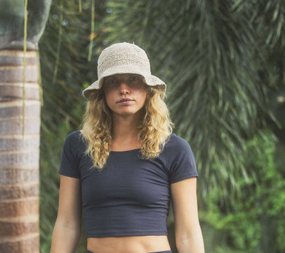 Hemp crochet floppy beach hat with boho style, worn by a person, showcasing its foldable design and wide brim for sun protection.
